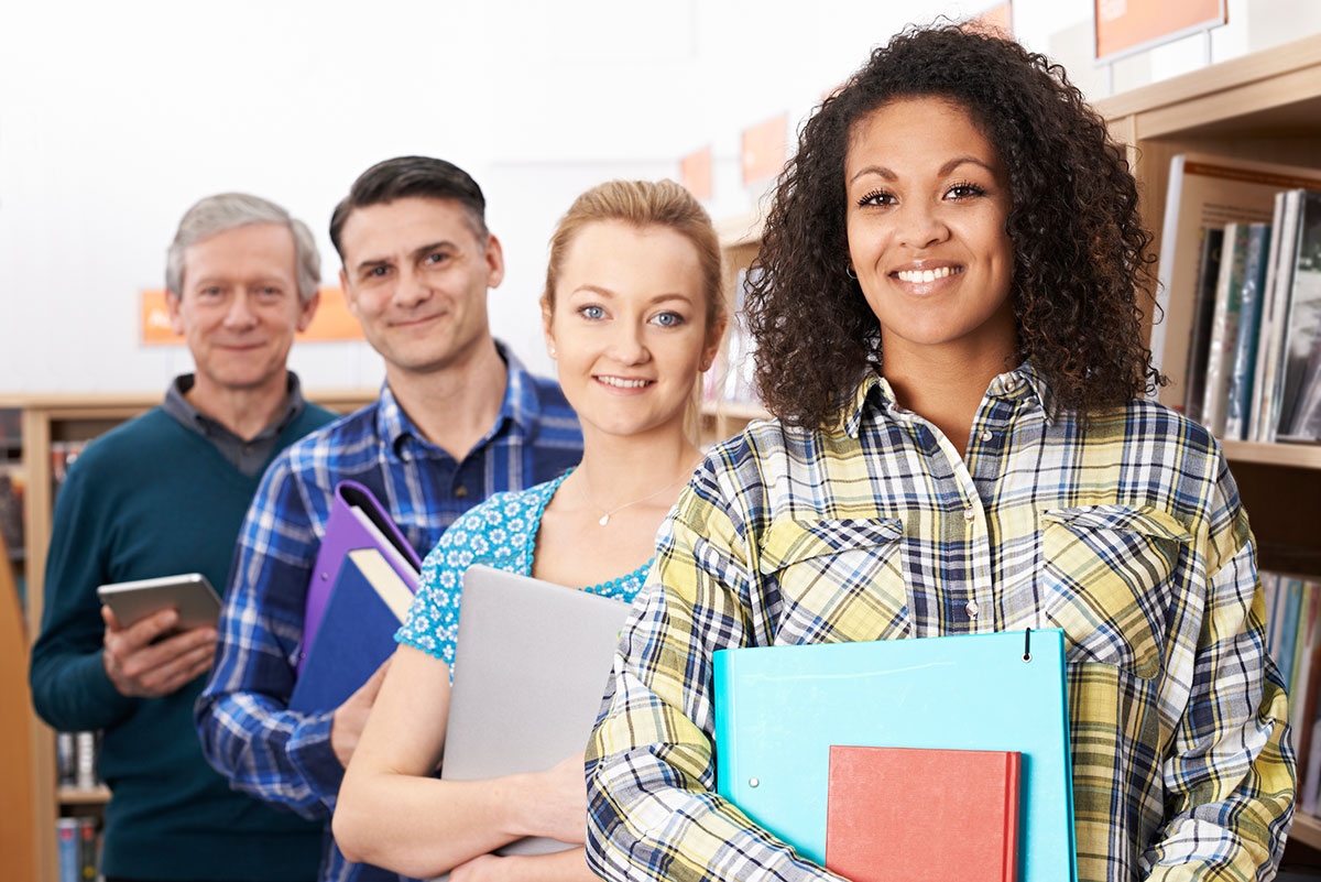 Group of mature students studying in library