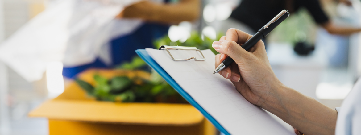 Person writing on a clipboard.
