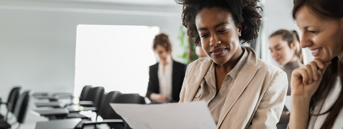 Two women looking at a document.