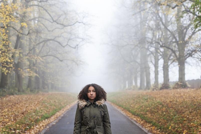 Woman standing in middle of road