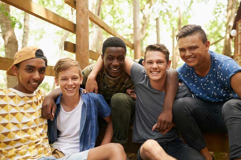 Diverse group of teen boys smiling