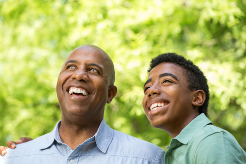 Parent and teen smiling.