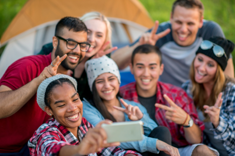 A group of young adults smiling and looking at the camera.