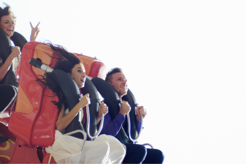 Young people on a roller coaster.