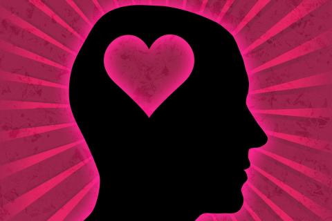 Silhouette of man's head with a heart where the brain would be. Light streams from the heart, surrounding the silhouette.