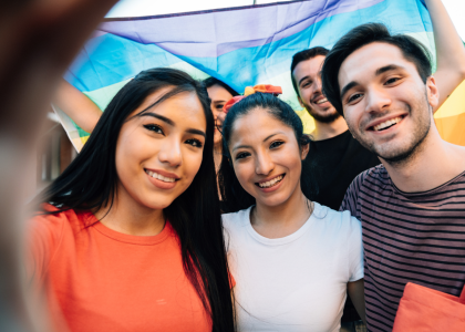 A group of teens smiling and looking at the camera.