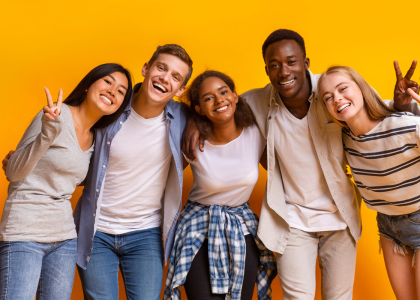Photo of 5 diverse teens in front of a yellow background