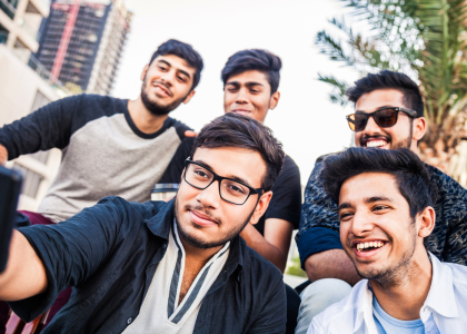 A group of young men gathering to take a selfie