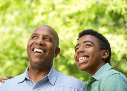 Parent and teen smiling.