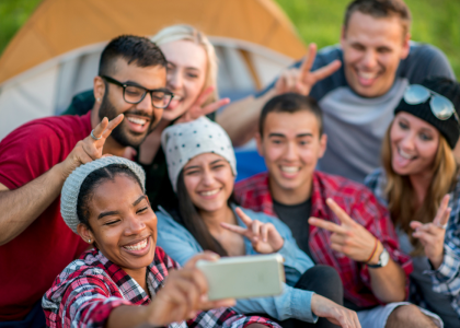 A group of young adults smiling and looking at the camera.