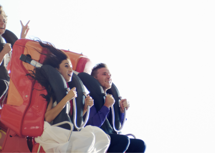 Young people on a roller coaster.