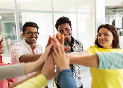 Group of teens high-fiving.