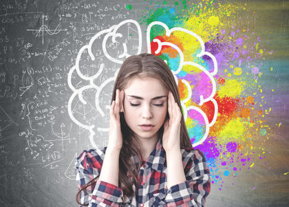 Person with their hands on their head in front of an illustrated brain background.