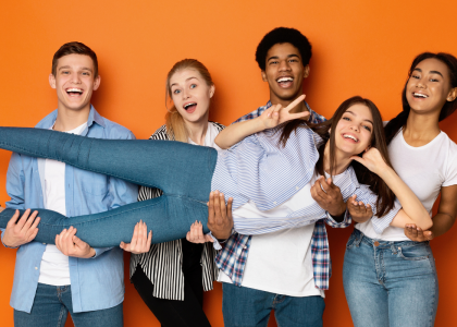 Four adolescents are holding up another as they lay horizontally.