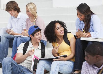 Group of diverse teens sitting on steps