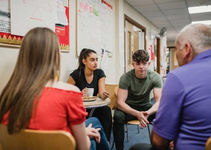 Group of teens sitting in a circle 