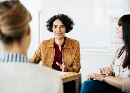 Woman talking to her colleagues at work