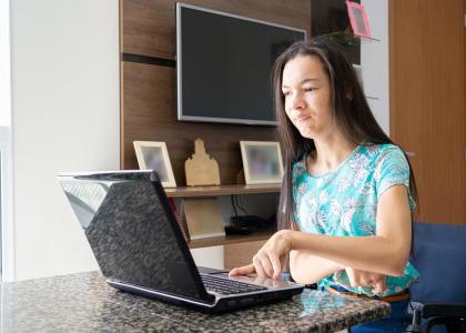 A teenager using a laptop.