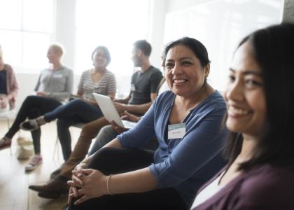 People in conference room watching webinar