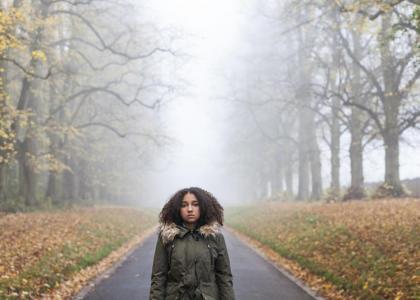 Woman standing in middle of road