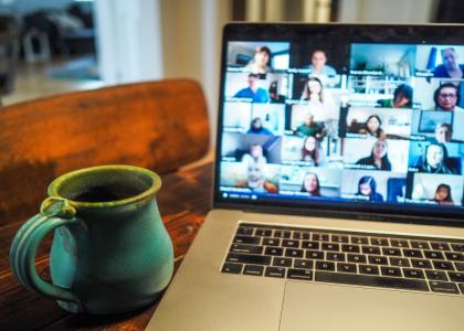 A photograph of a computer screen showing a virtual meeting. 