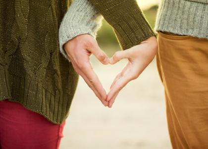 Youth making a heart with their hands