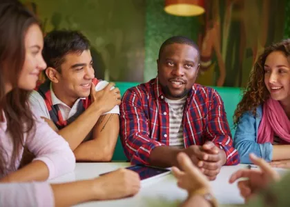 Diverse teens talking at a table 