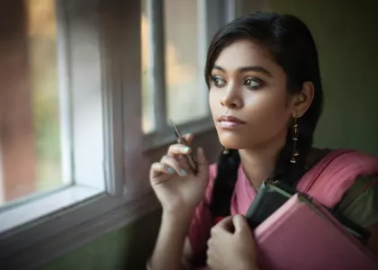 Young Asian woman looking outside