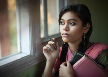 Young Asian woman looking outside