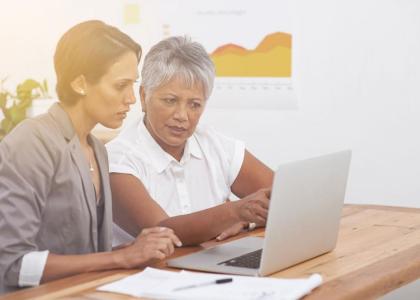 Two female workers looking at computer
