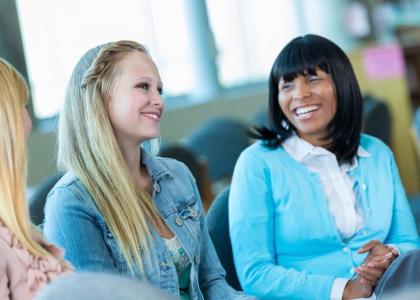 Teens and adults talking in group.