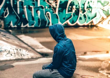 teen in park with graffiti