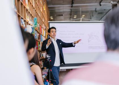 Man teaching  in front of screen 