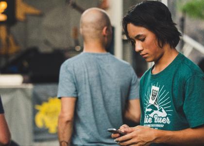 Teen boy looking at his phone