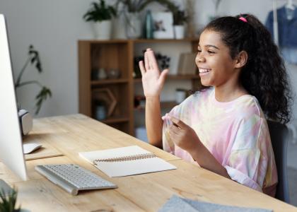 Teen girl sitting in front of a computer screen