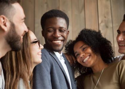 Group of happy young men and women engaging in conversation