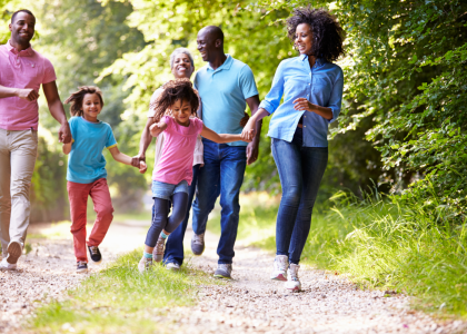 Cheerful multigeneration family taking a walk outdoors