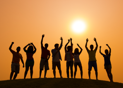 Group of youth with their hands raised to the sky