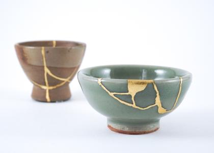 Two Japanese sake cups. Cracks in the cups were mended using Kintsugi gold restoration technique. 