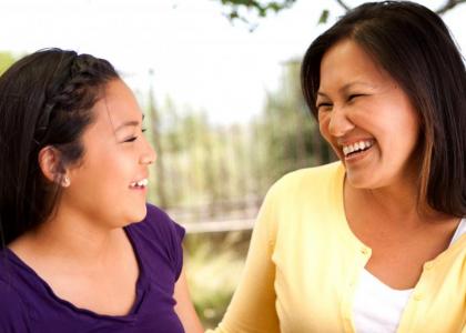 Happy mother and teen daughter engaged in conversation